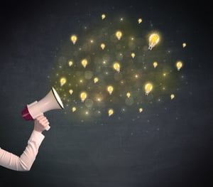 Caucasian business hand holding megaphone with yellow lightbulbs