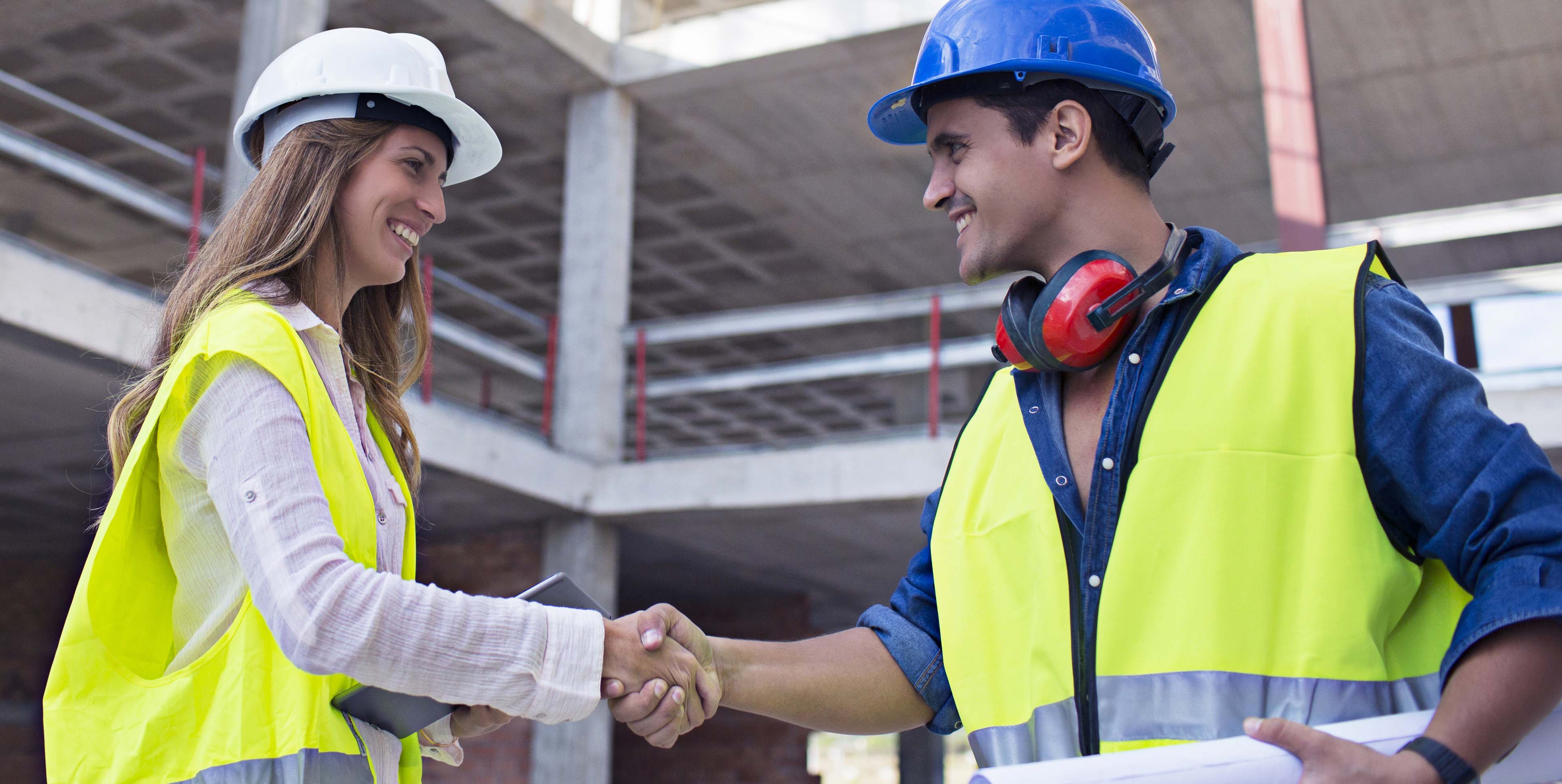 Construction worker friends shaking hands